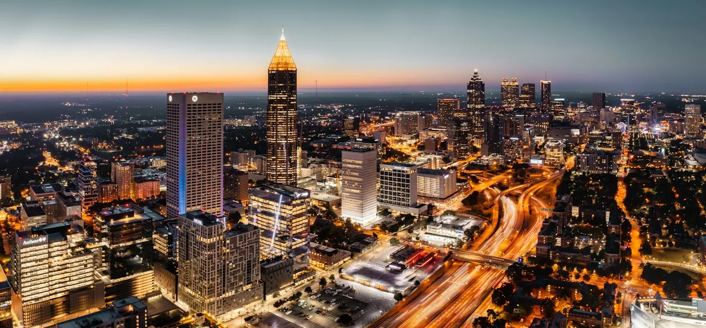Aerial view of Midtown Atlanta at dusk with traffic light trails