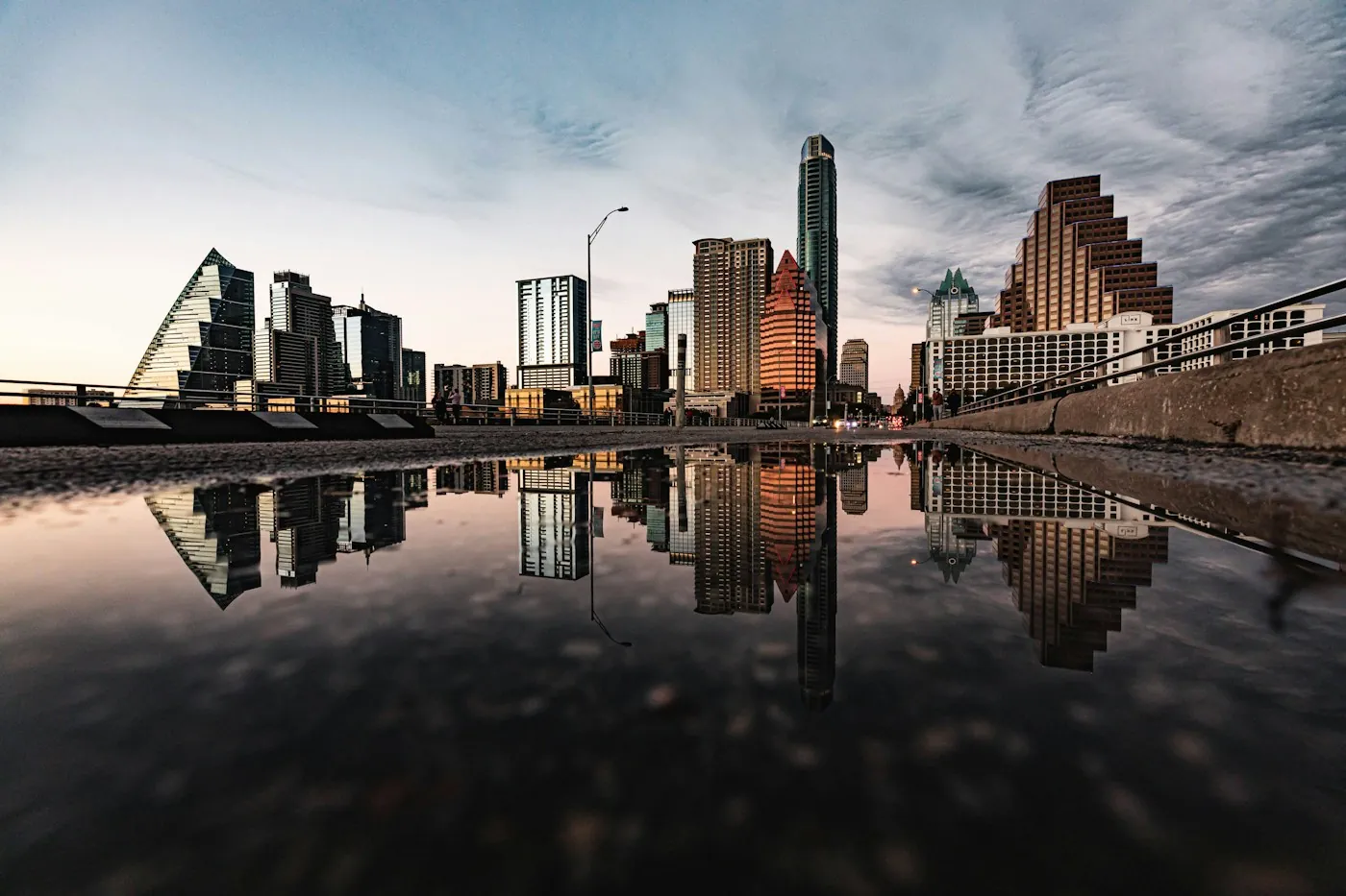 Austin high-rises reflected in still water at dusk