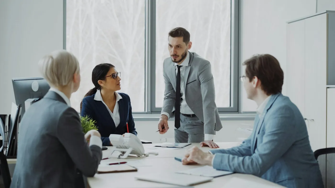 Executives discussing a deal in a modern office