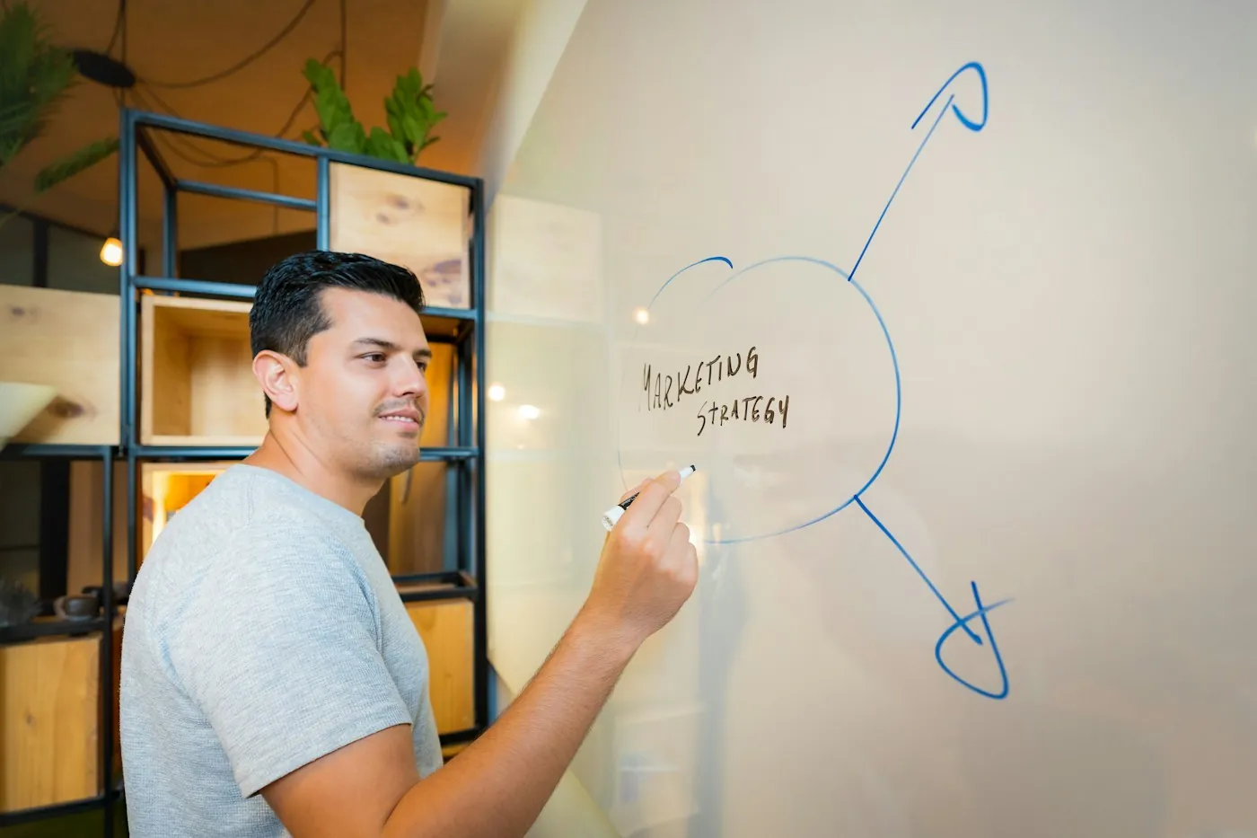Strategist sketching a marketing framework on a whiteboard