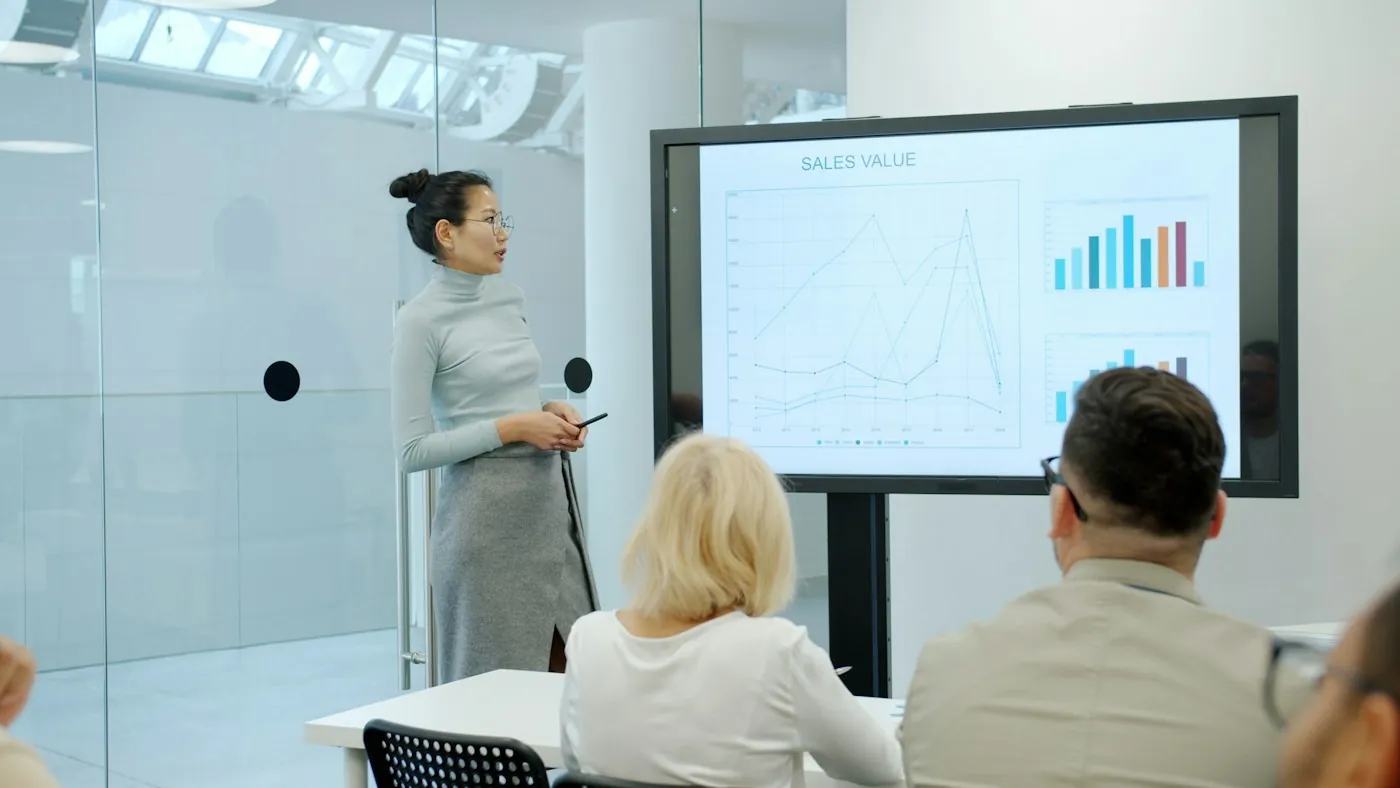 Presenter walking a client team through campaign results on a screen