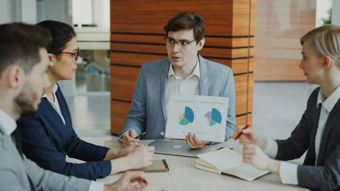 Two professionals reviewing documents in a consultation meeting