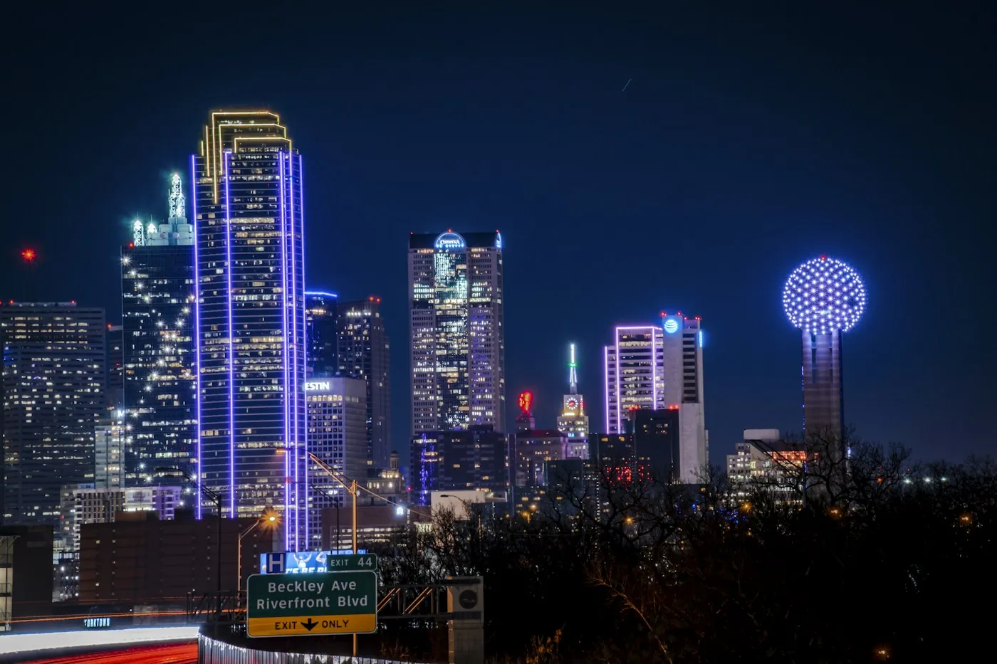 Downtown Dallas towers and Reunion Tower lit up at night