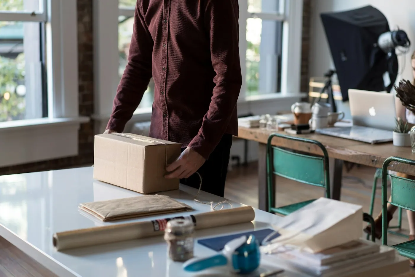 Small business owner packing customer orders at a workbench