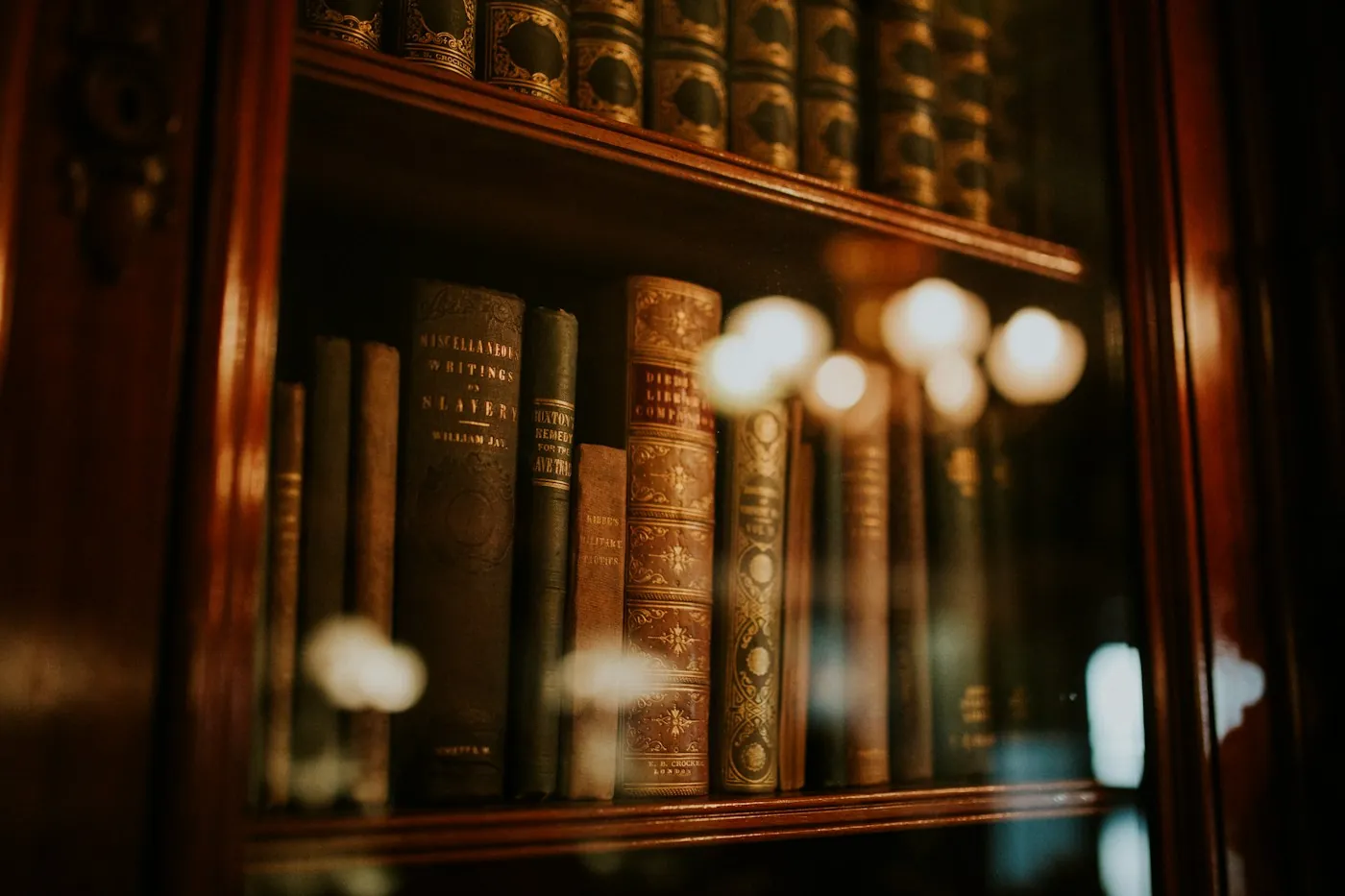 Law books behind glass in a dark wooden bookcase