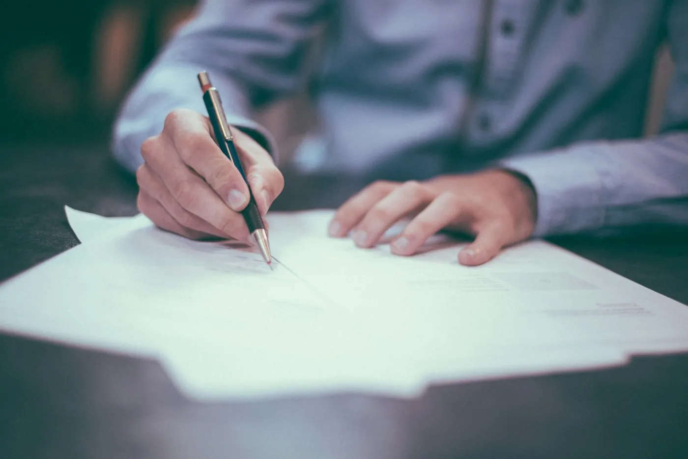 Attorney signing a document at a desk