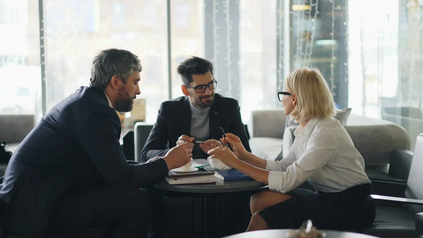 Attorneys meeting with a client around a table
