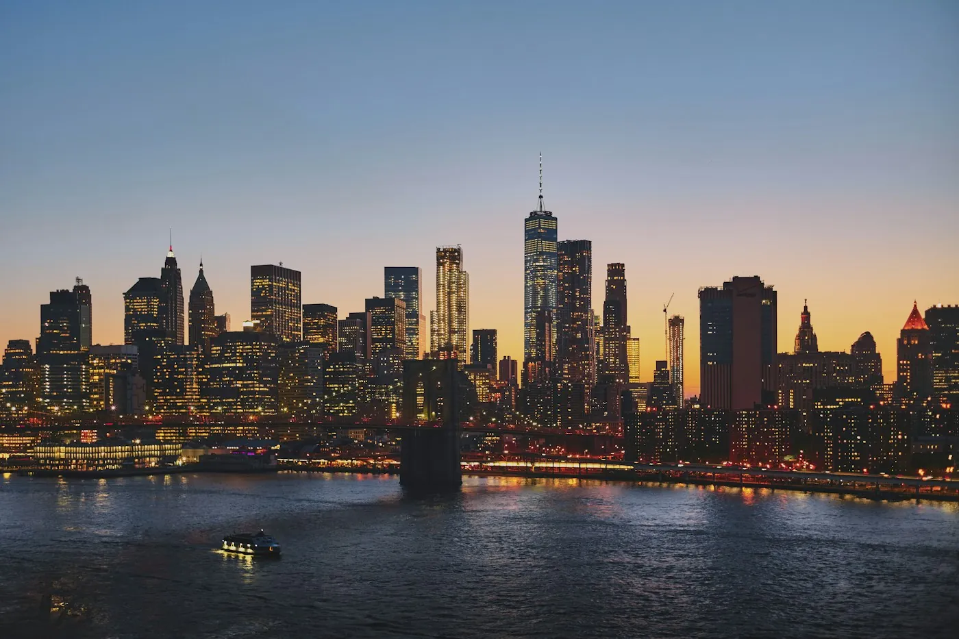 Midtown Manhattan skyline lit up at night across the river