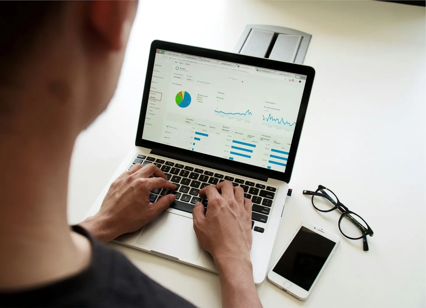 Marketer reviewing ad performance reports on a laptop