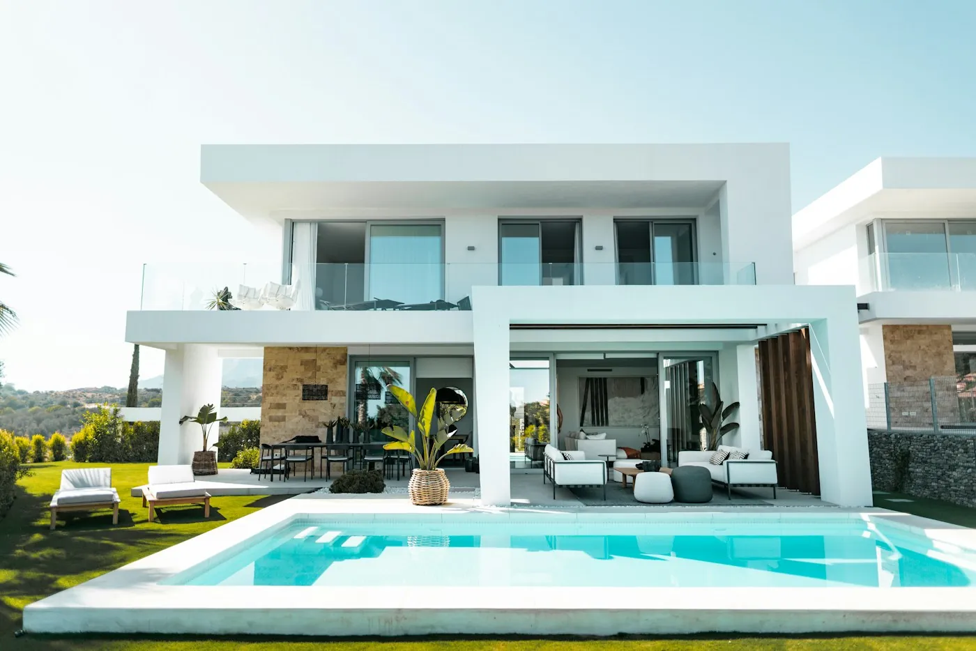 Contemporary white house with large windows and a lawn